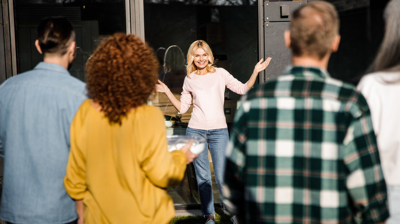 Guests arrive at a housewarming