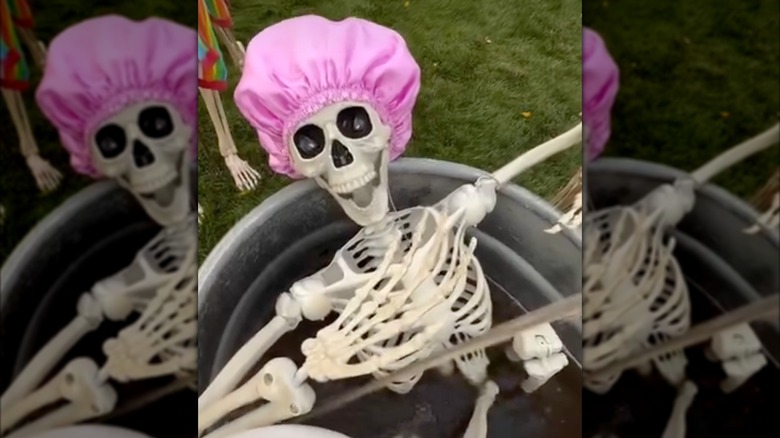 Skeleton with a pink shower cap in a bathtub outside