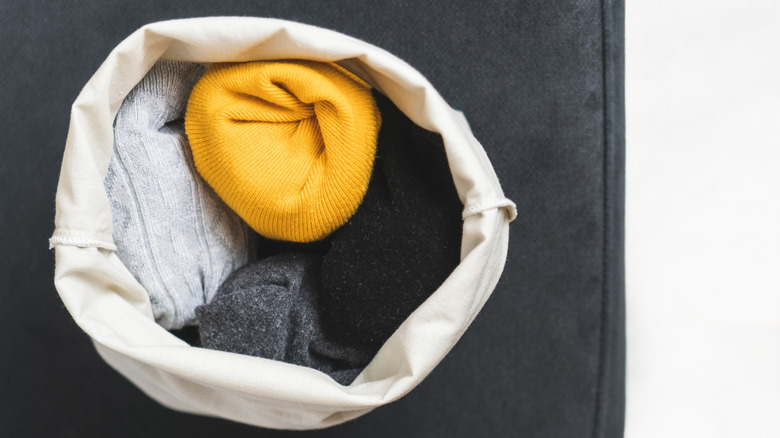 A fabric bag is filled with socks.