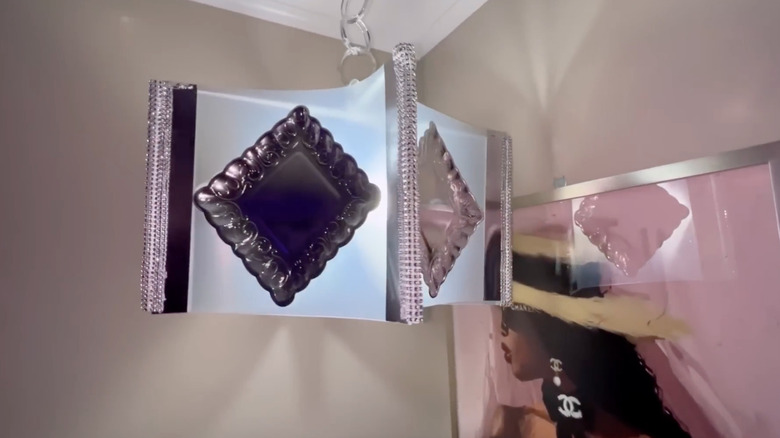 A glam ceiling hanging light made from chopping mats in bedroom