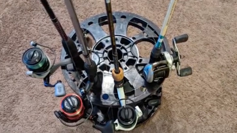 A fishing pole holder made from an old garden hose reel.
