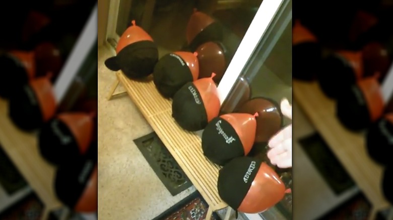 Bench with hats filled with balloons in them to  dry out and reshape the hats