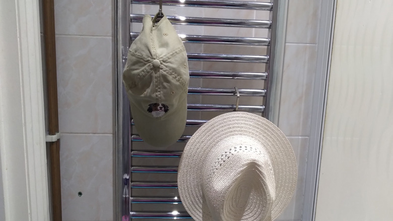 two hats on towel rack