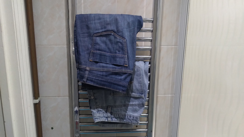 jeans hanging on towel rack