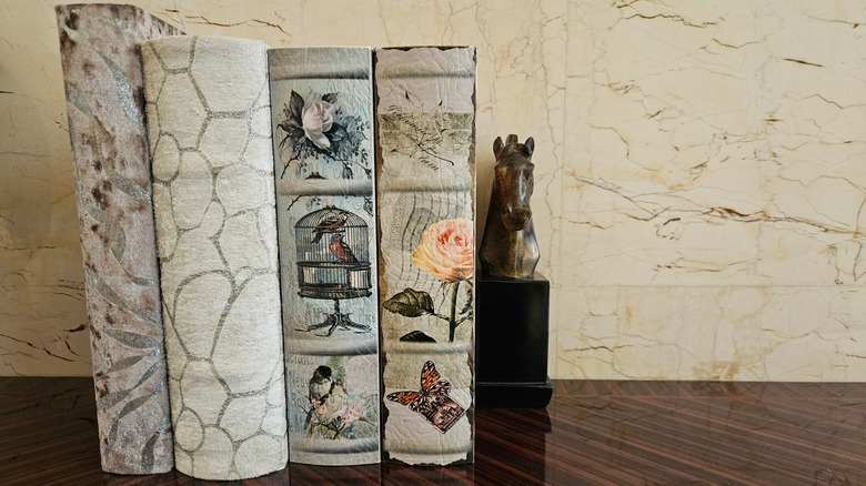four antique books help up by metal horse head bookend