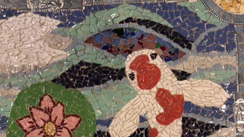 A mosaic piece of art with a pond theme