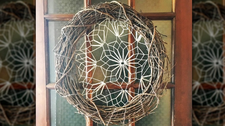Doily in center of natural wreath hanging on door