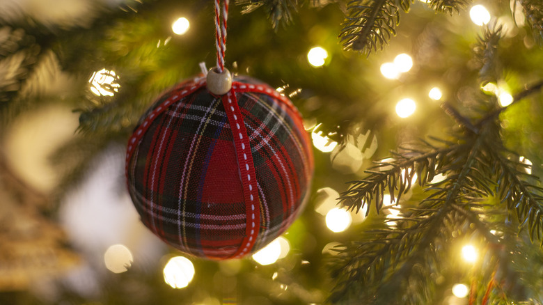 A round ball is wrapped in a vintage hankie and finished with ribbon.