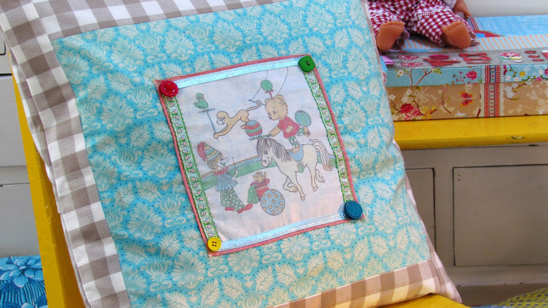A cushion cover made from scrap fabric and a kids' vintage handkerchief.