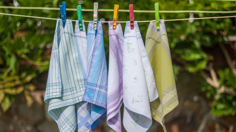 Vintage handkerchiefs hanging on a clothesline drying in the sun and wind.
