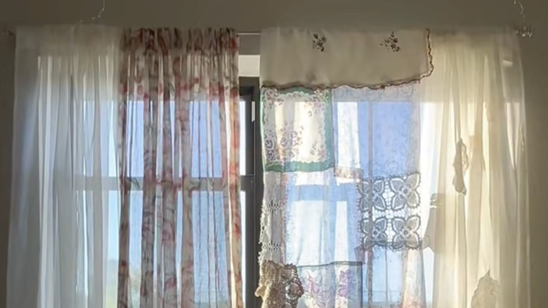 A curtain made from hankies adorns the window in a bedroom.