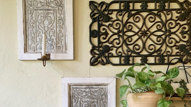 A large cast iron trivet hanging on a wall