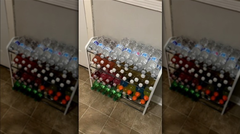 Three-tiered shoe rack used to store stacks of water bottles, sports drinks, and juice bottles.