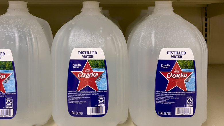 Close up of gallons of distilled water on supermarket shelf