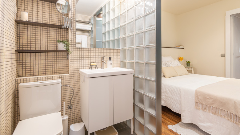 Glass bricks form a partition between toilet and sleeping areas