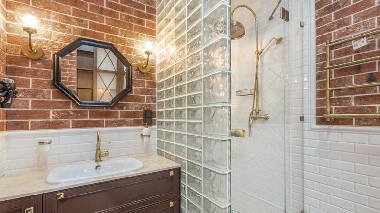 One wall of a shower stall is built with glass blocks