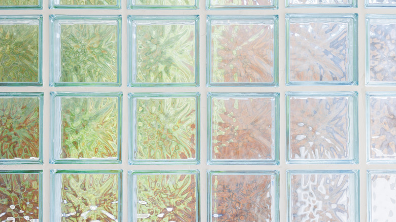 A panel of textured glass bricks in pastel shades