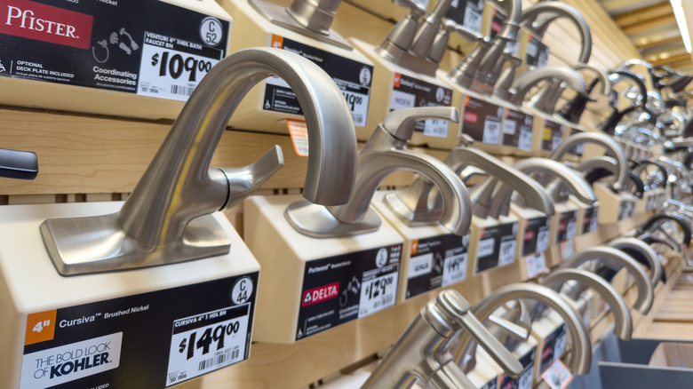 Faucets from Delta, Kohler, and other brands on display in a store