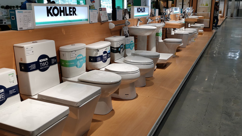 Different types of toilets from Kohler on display at a store