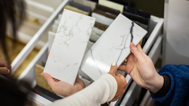 Hands holding different marble samples