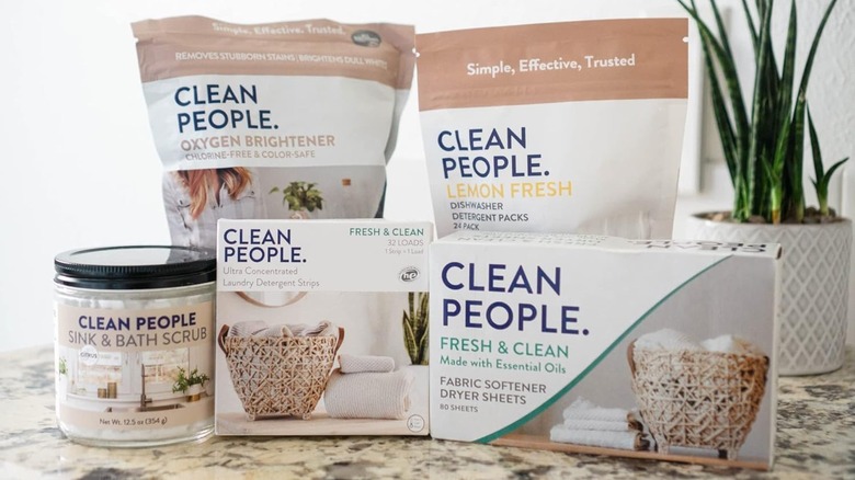 Clean People Laundry Detergent Sheets and related products sit next to a snake plant on a granite countertop