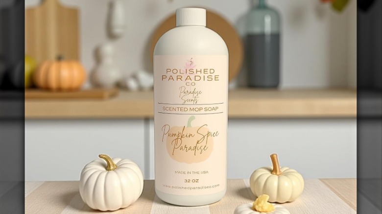 Polished Paradise Co. Scented Mop Soap on kitchen countertop next to pumpkin decor