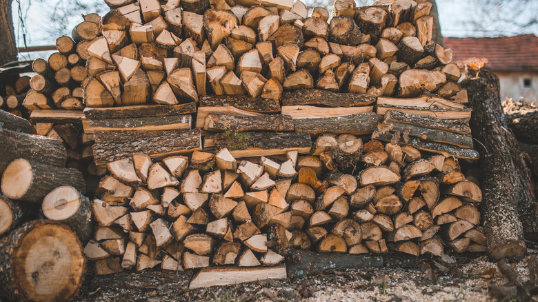 Mixed sizes and shapes of firewood in stack.