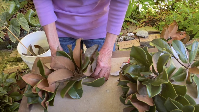 woman preparing magnolia leaf garland