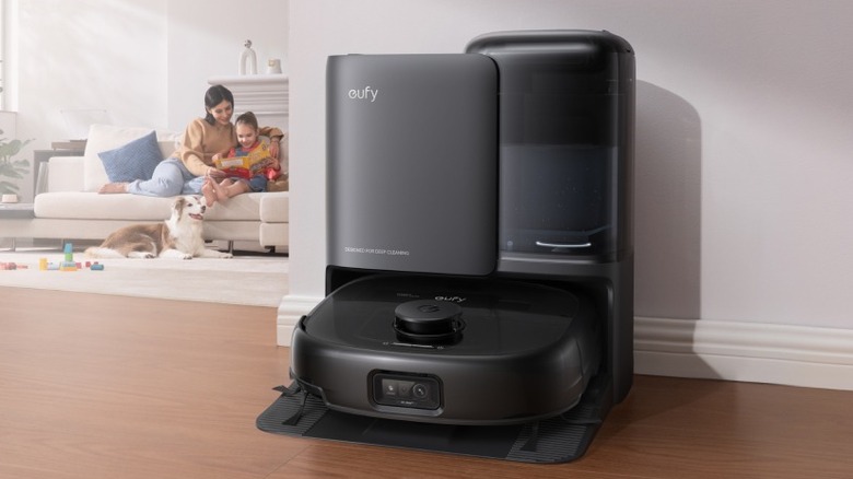 A black eufy robot vacuum inside its base