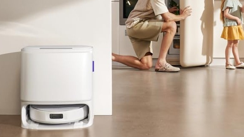 A white robot vacuum docked in its station