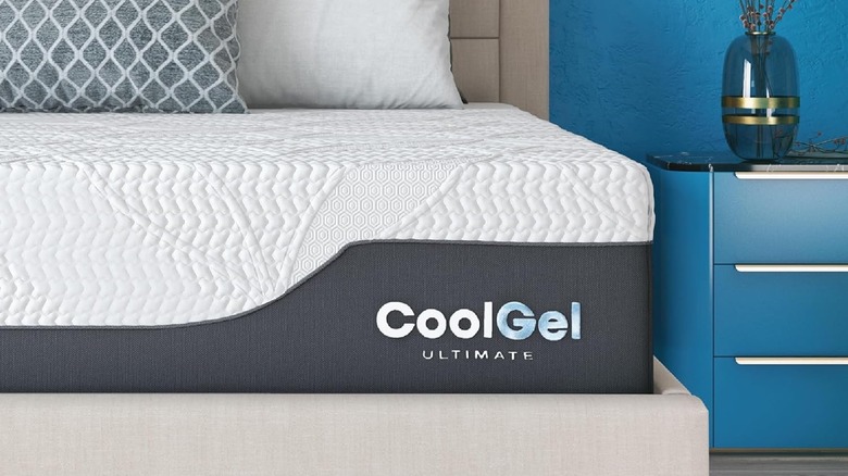 Classic Brands Cool Gel Chill Memory Foam Mattress on a bedframe with a bright blue wall in the background