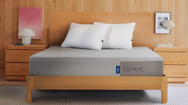 The Casper Element Memory Foam Mattress on a wooden bedframe with wood decor in the background