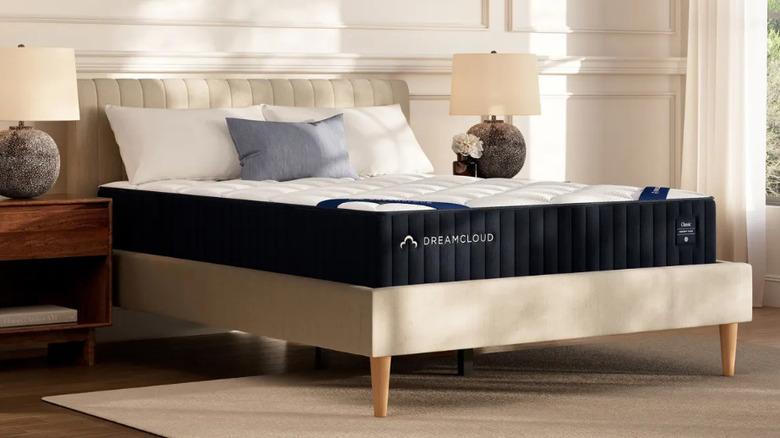The DreamCloud Classic Memory Foam Mattress on a beige bedframe in a neutral decor bedroom
