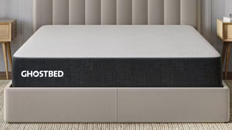 The GhostBed Essential Series mattress on a bedframe in a neutral decor bedroom
