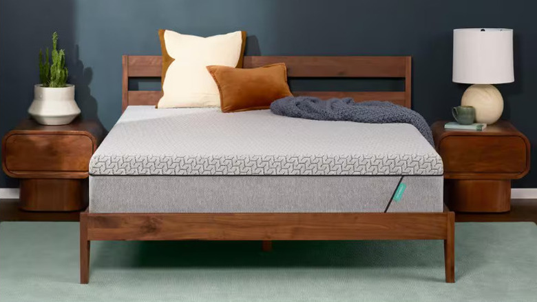 The Tuft & Needle Mint 12-inch Mattress on a wood bedframe with nightstands and decor