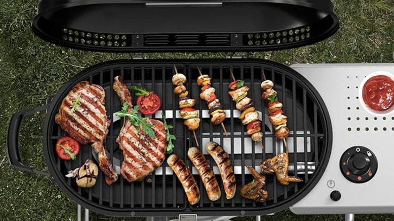 Different types of meat cooking on a grill from a top down view