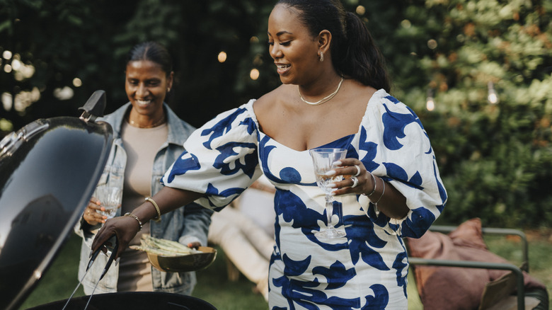 A woman cooking food on a grill