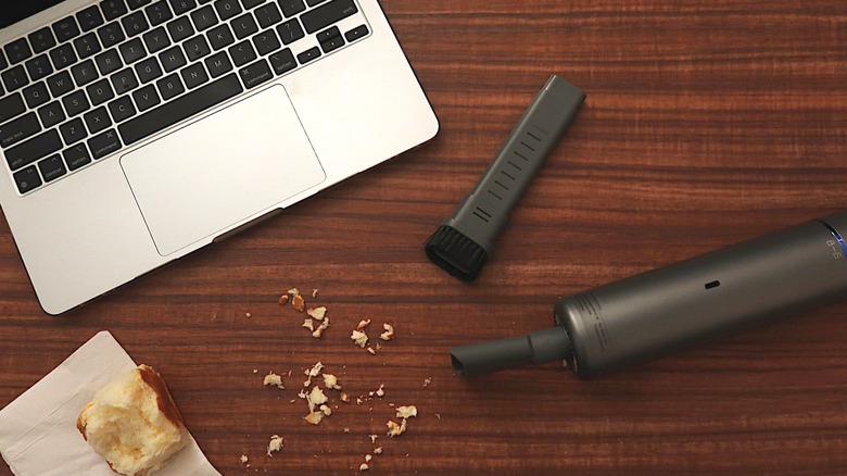 handheld vacuum near crumbs