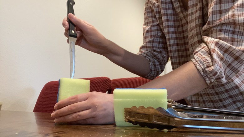 Person cutting sponge with knife