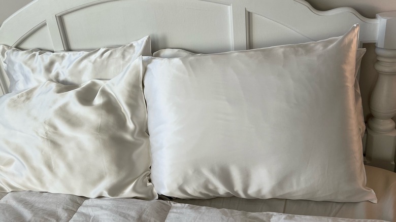 two pillows arranged on bed
