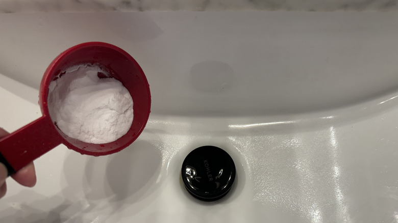 Adding baking soda to drain