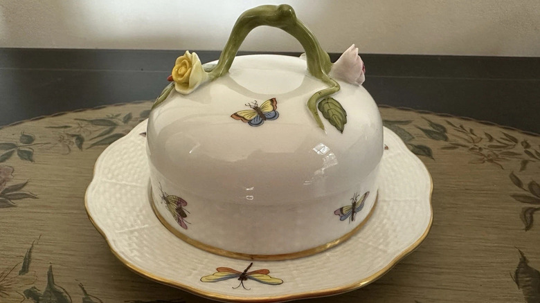 A Herend Queen Victoria covered butter dish with a floral pattern with butterflies and dragonflies