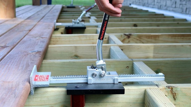 Using a deck board straightener on the outside decking area