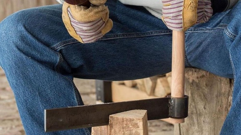 Man using a froe to cut wood