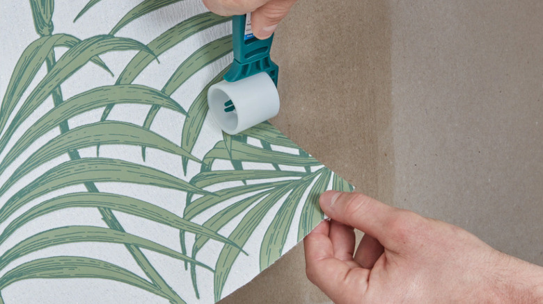 Using a seam roller on a leather patch