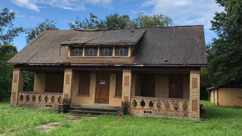 Abandoned house with damaged roof