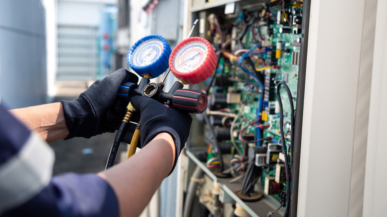 repair person testing an HVAC system