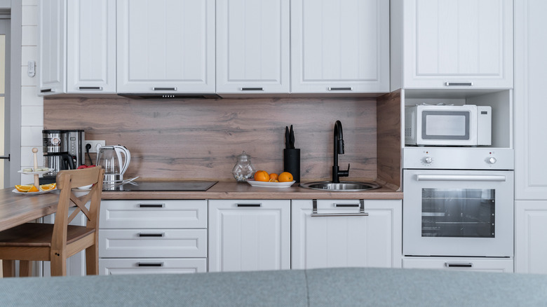an all-white kitchen with white appliances