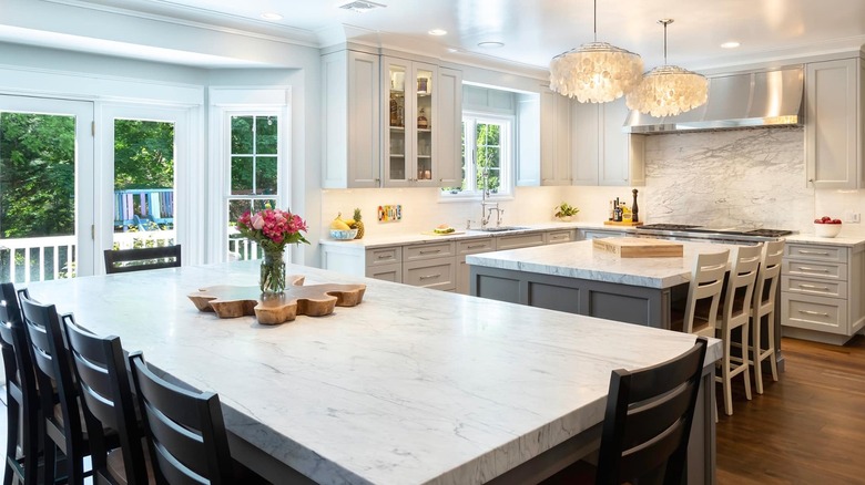 https://www.housedigest.com/img/gallery/what-are-double-kitchen-islands-and-are-they-worth-installing/intro-1683722018.jpg