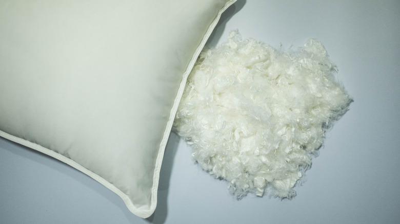synthetic stuffing spilling from pillow